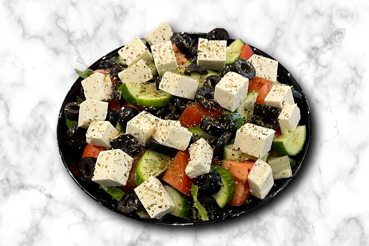 Greek Salad - lettuce, tomatoes, cucumbers, feta cheese and olives with house dressing - Mediterranean classic